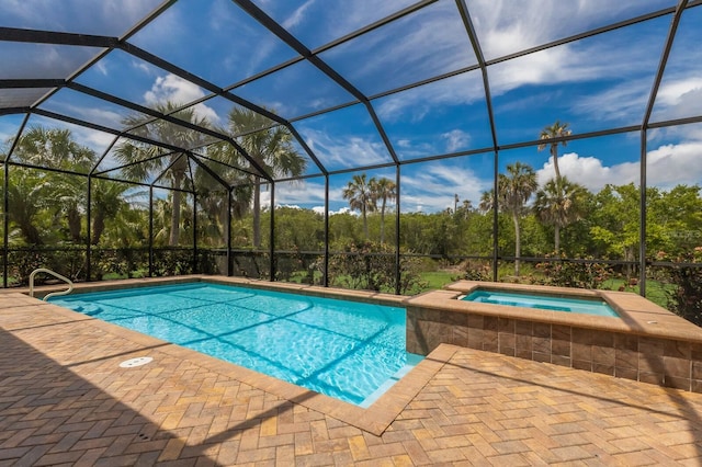 view of swimming pool featuring a lanai, an in ground hot tub, and a patio