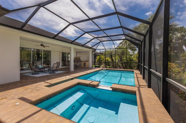 view of pool with an in ground hot tub, a patio, ceiling fan, and a lanai