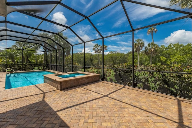 view of pool featuring an in ground hot tub, a patio area, and a lanai