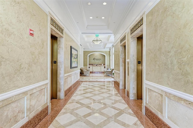 hallway with a raised ceiling and ornamental molding