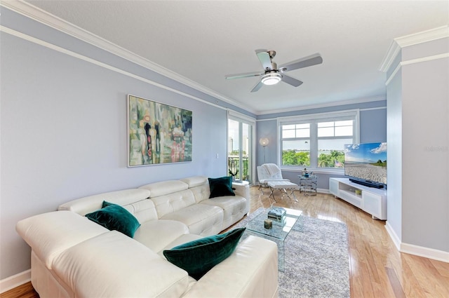 living room featuring ceiling fan, light wood-type flooring, and ornamental molding