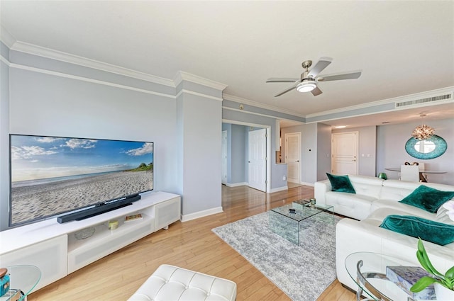 living room featuring light wood-type flooring, ceiling fan, and crown molding