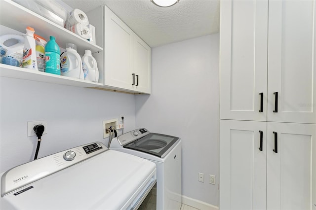 laundry room featuring cabinets, independent washer and dryer, and a textured ceiling