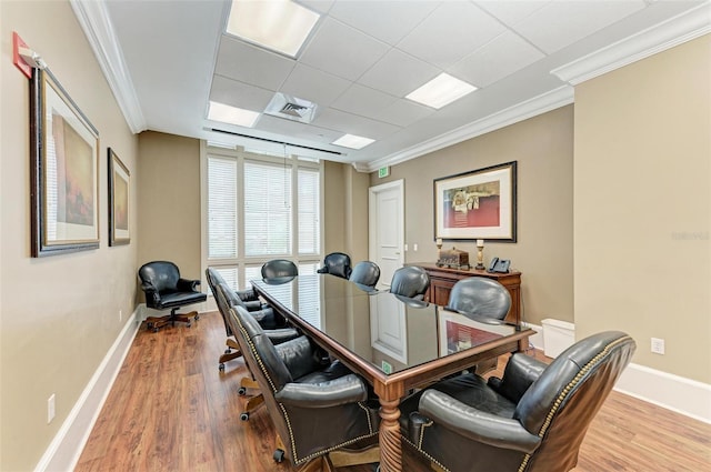 office featuring a paneled ceiling, crown molding, and light hardwood / wood-style floors