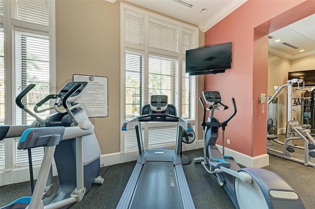 workout area with a wealth of natural light and ornamental molding