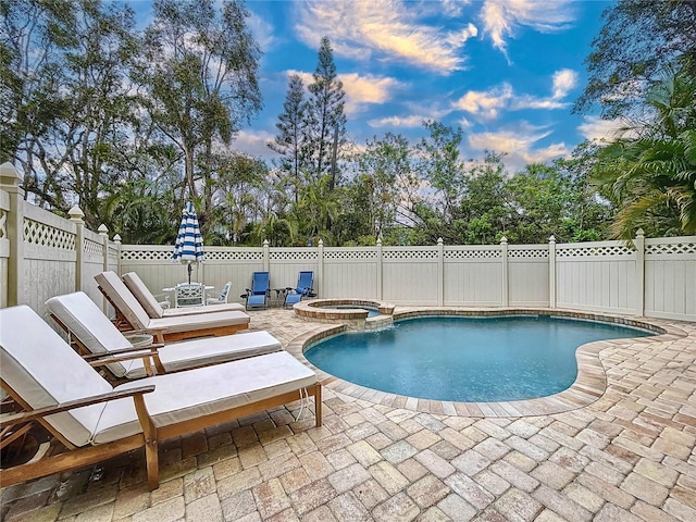 view of pool featuring an in ground hot tub and a patio area