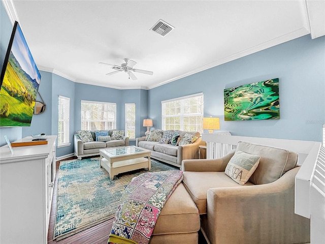 living room featuring crown molding and ceiling fan