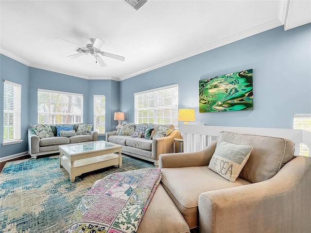 living room featuring ceiling fan, crown molding, and a healthy amount of sunlight