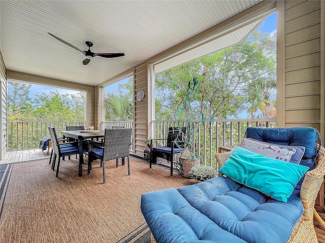 sunroom featuring ceiling fan