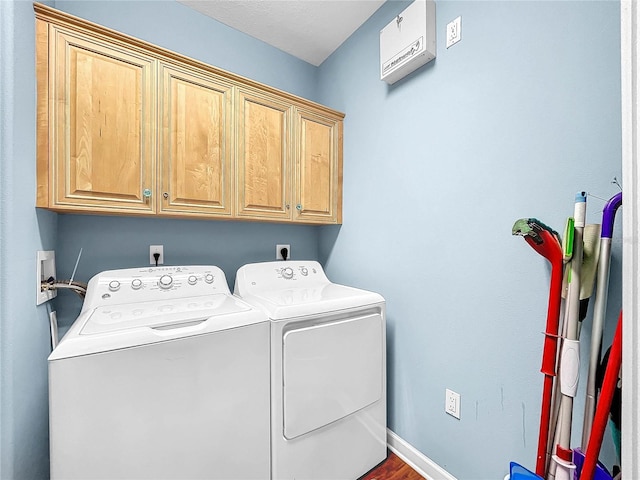 washroom with cabinets, washer and clothes dryer, and hardwood / wood-style floors