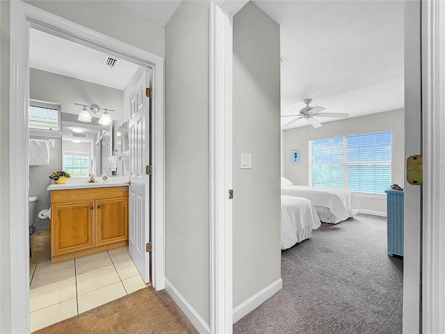 hallway with light colored carpet