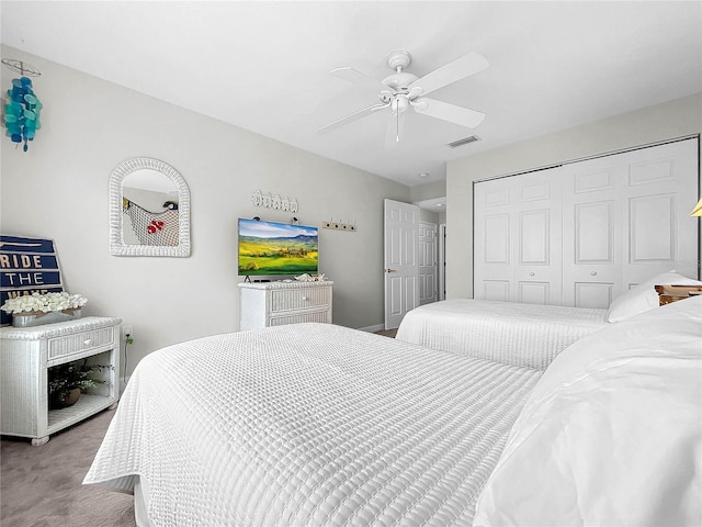 bedroom featuring a closet, ceiling fan, and carpet