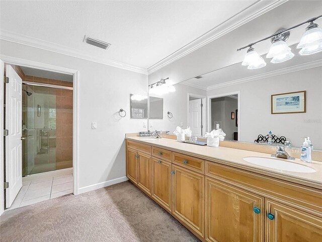 bathroom featuring a shower with door, vanity, ornamental molding, and tile patterned floors