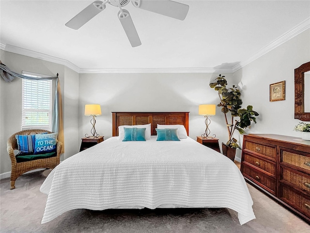 carpeted bedroom featuring crown molding and ceiling fan