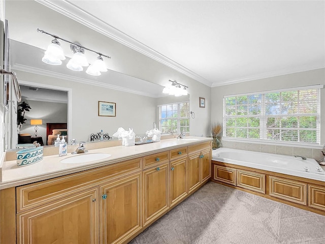 bathroom with ornamental molding, vanity, and a tub