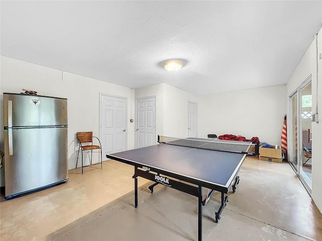 rec room with a textured ceiling