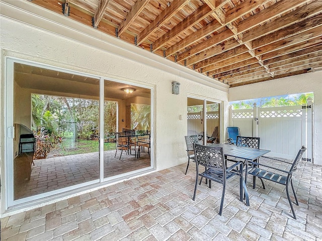 sunroom / solarium featuring beamed ceiling and wooden ceiling