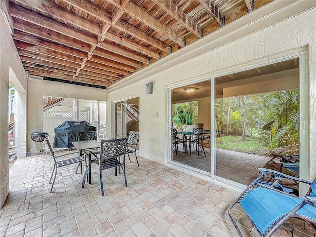 sunroom with wooden ceiling and beamed ceiling