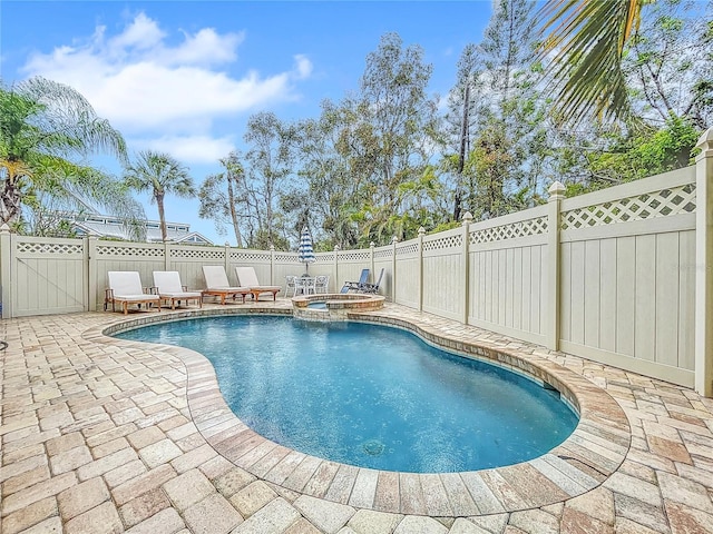 view of swimming pool with a patio area and an in ground hot tub