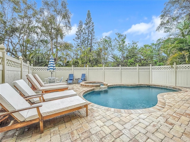 view of pool featuring an in ground hot tub and a patio area