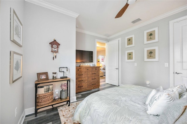 bedroom with dark wood-type flooring, ceiling fan, and ornamental molding