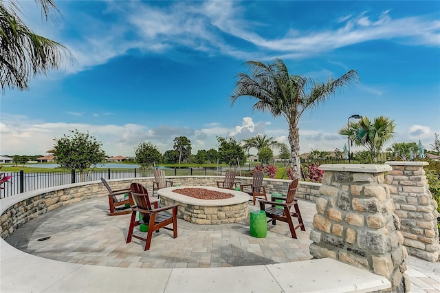 view of patio / terrace featuring a water view and a fire pit