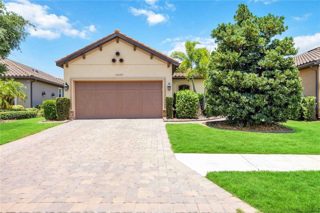 mediterranean / spanish home with a front yard and a garage