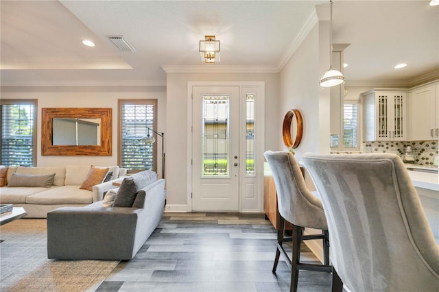 interior space with crown molding and dark wood-type flooring