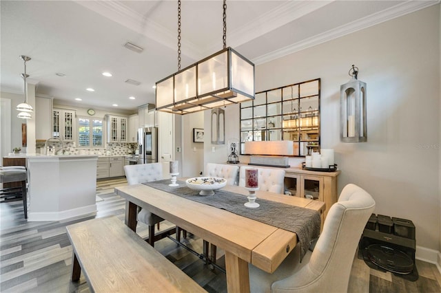 dining room featuring wood-type flooring and ornamental molding