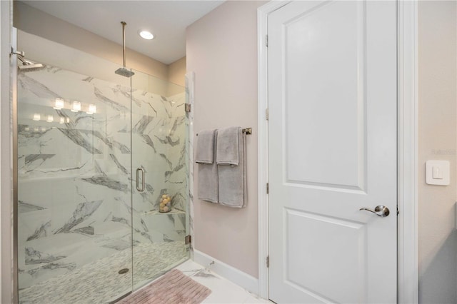 bathroom featuring a shower with door