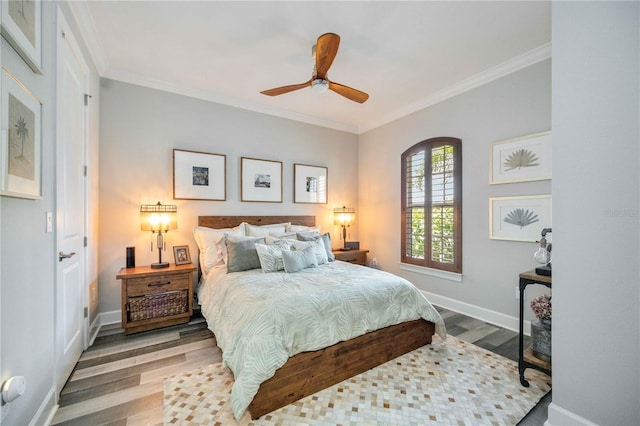 bedroom with wood-type flooring, ceiling fan, and crown molding