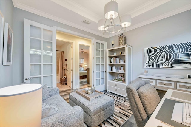 home office featuring french doors, built in features, a notable chandelier, crown molding, and hardwood / wood-style floors