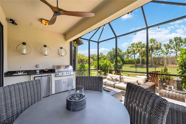 view of patio with an outdoor kitchen, an outdoor hangout area, area for grilling, ceiling fan, and sink