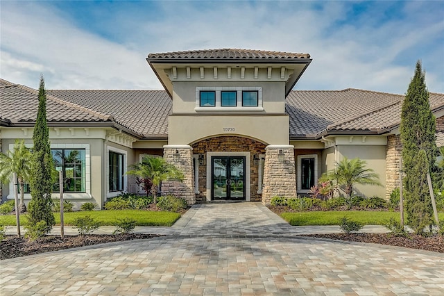 mediterranean / spanish home featuring french doors