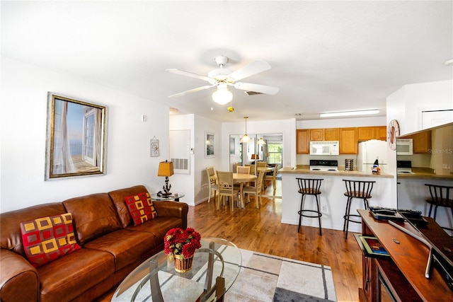 living room with ceiling fan and light hardwood / wood-style floors