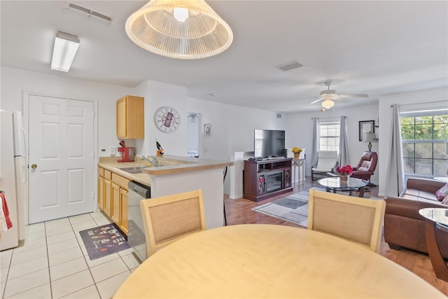 dining room with sink, ceiling fan, and light tile floors