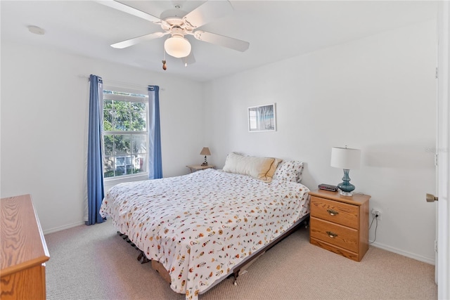 bedroom featuring light carpet and ceiling fan