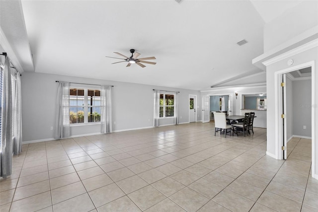 unfurnished living room featuring ceiling fan, plenty of natural light, light tile patterned floors, and vaulted ceiling