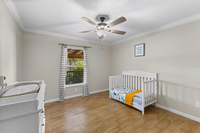 bedroom featuring a textured ceiling, ceiling fan, and ornamental molding