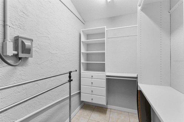 spacious closet featuring light tile patterned flooring