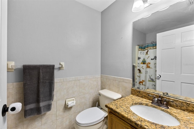 bathroom featuring vanity, toilet, tile walls, and curtained shower