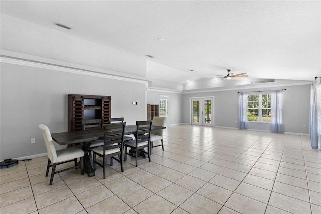 tiled dining room featuring a raised ceiling, ceiling fan, crown molding, and vaulted ceiling