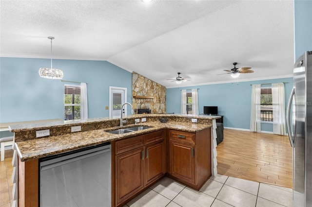 kitchen with pendant lighting, ceiling fan with notable chandelier, sink, a healthy amount of sunlight, and stainless steel appliances