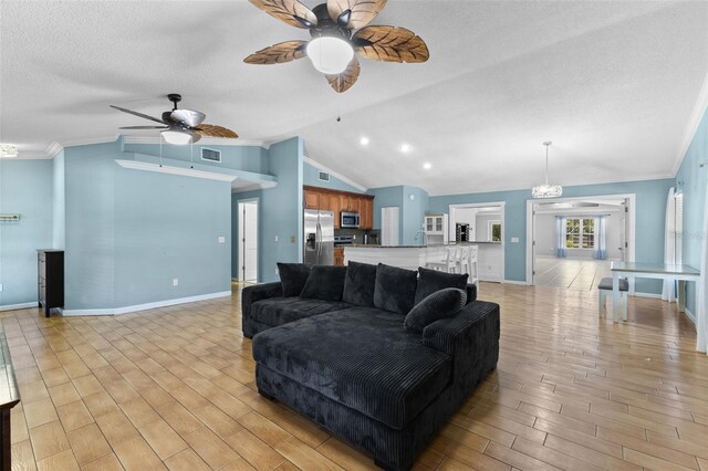 living room featuring ceiling fan with notable chandelier, crown molding, and lofted ceiling