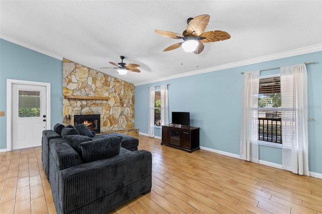 living room with ornamental molding, a fireplace, and vaulted ceiling