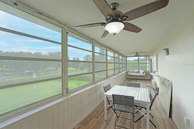 sunroom featuring ceiling fan