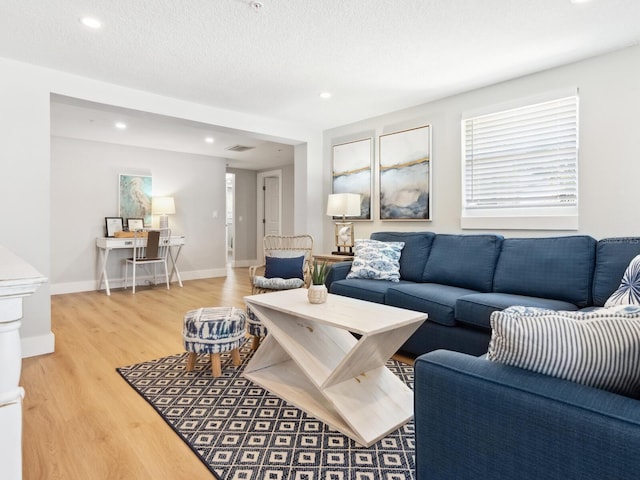 living room with hardwood / wood-style floors and a textured ceiling