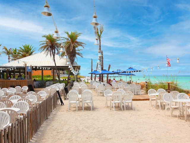 view of property's community with a beach view, a gazebo, and a water view