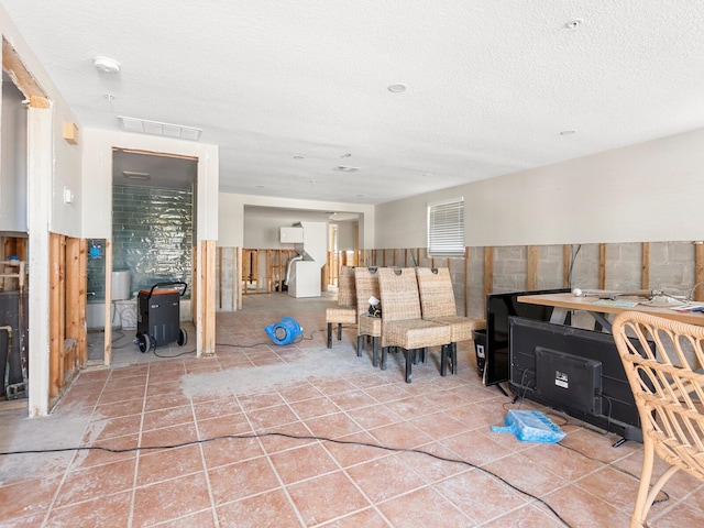 interior space with tile walls and a textured ceiling