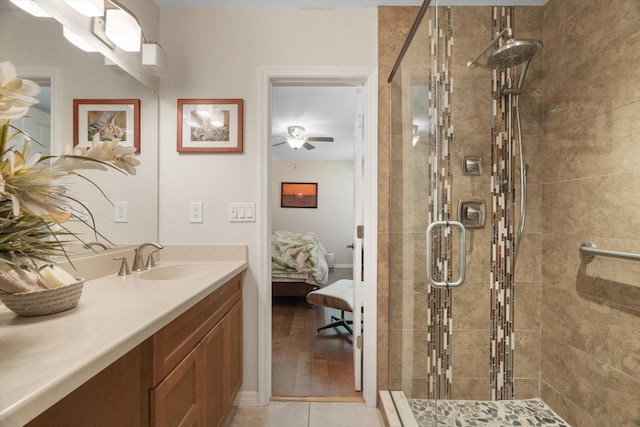 bathroom featuring ensuite bathroom, a stall shower, tile patterned flooring, and vanity